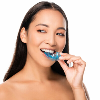 smiling naked asian woman with mouth guard isolated on white smiling naked asian woman with mouth guard isolated on white