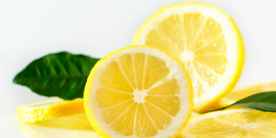 Fresh juicy lemon slices on white background. Citrus fruit high in vitamin C. Fresh juicy lemon slices on white background. Citrus fruit high in vitamin C. Antioxidant for healthy diet.